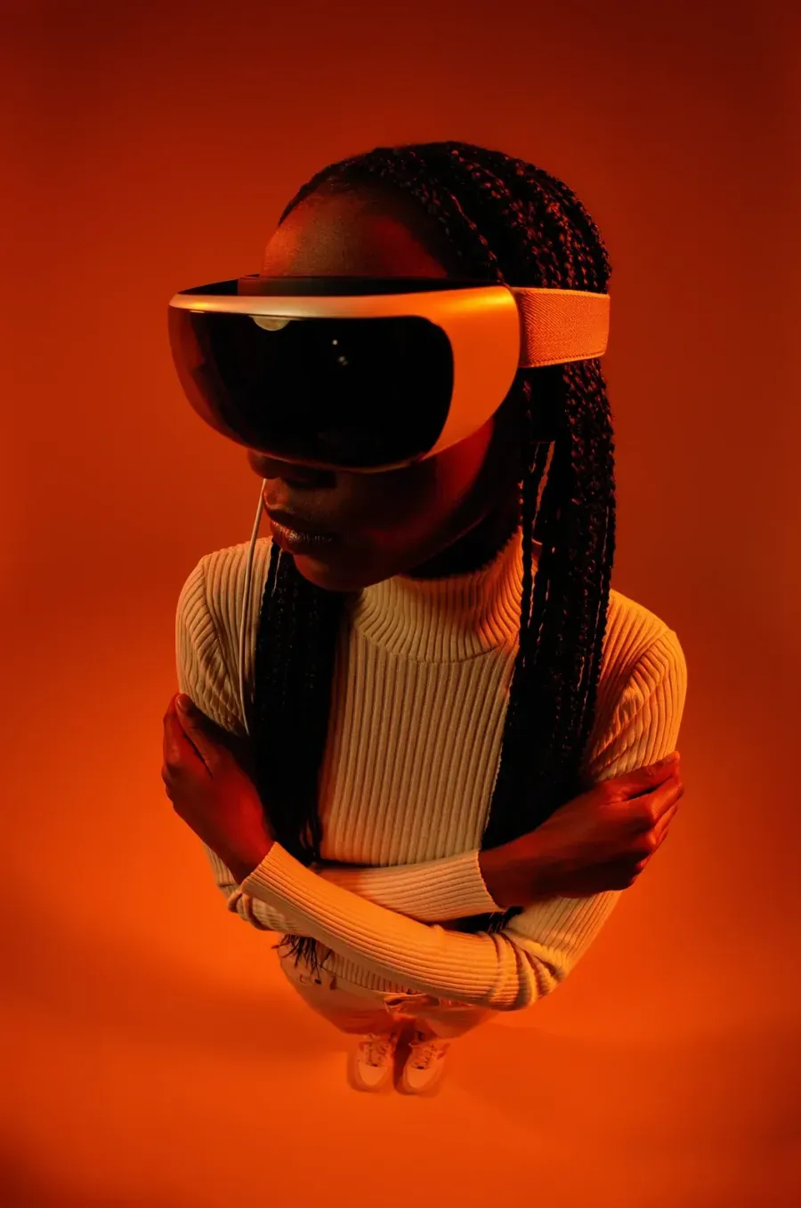 portrait in orange light, VR visor, braids, studio flash